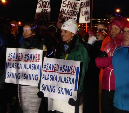 UAA assistant nordic coach Sara Studebaker-Hall (center, white hat) at the #savealaskaskiing rally in Anchorage, Alaska, on Nov. 10, 2016. Former UAA skier and current USST member Sadie Bjornsen (pink jacket) is to her left. (Photo: Gavin Kentch)