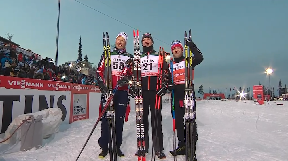 The men's podium in Sunday's 15 k classic at the Ruka World Cup in Kuusamo, Finland: with Finnish winner Iivo Niskanen (c) and Norway's Emil Iversen (l) in second and Martin Johnsrud Sundby (r) in third. (Photo: NBC Sports screen shot)