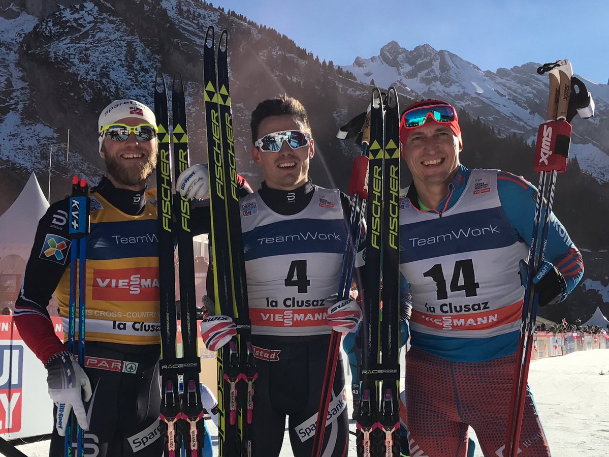 The men's 15 k freestyle mass start podium on Saturday at the World Cup in La Clusaz, France, with Norway's Finn Hågen Krogh (c) in first, Martin Johnsrud Sundby (l) in second, and Russia's Alexander Legkov (r) in third. (Photo: FIS Cross-Country/Twitter)