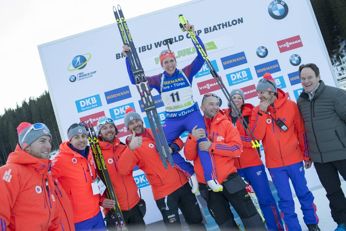 Susan Dunklee being hoisted up by her US Biathlon support team at the IBU World Cup in Pokljuka, Slovenia, after tying her career-best result in a pursuit. Dunklee placed fifth on Saturday for a season best as well. (Photo: USBA/NordicFocus)
