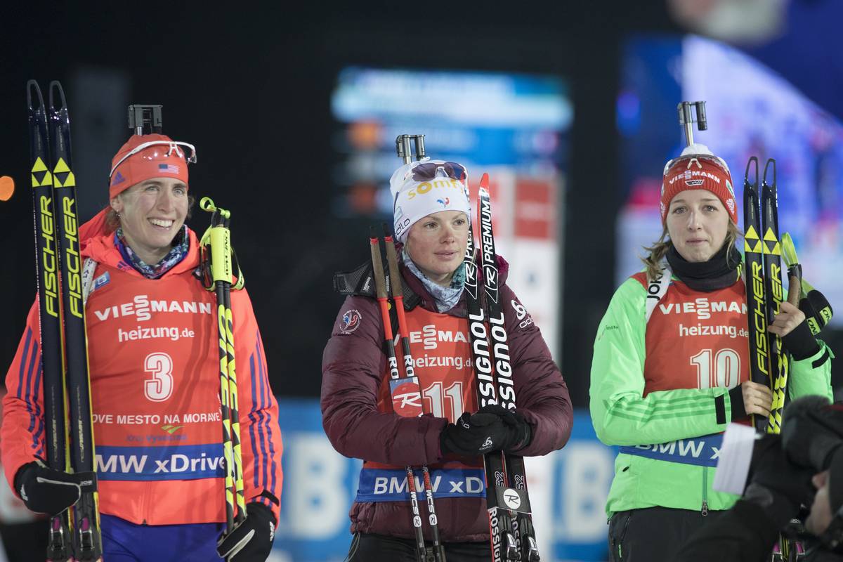 American Susan Dunklee (l) during the flower ceremony after placing fourth in the IBU World Cup pursuit on Saturday in Nove Mesto, Czech Republic, alongside France's Marie Dorin Habert (c) in fifth, and Germany's Franziska Preuss (r) in sixth. (Photo: USBA/NordicFocus)