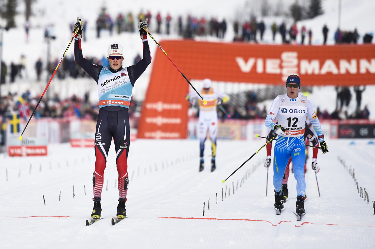 Norway's Johannes Høsflot Klæbo celebrates his second-place finish in the men's 15 k classic pursuit, ahead of Finland's Matti Heikkinen (12) in third, at the World Cup mini tour in Lillehammer, Norway. (Photo: Fischer/NordicFocus.com)