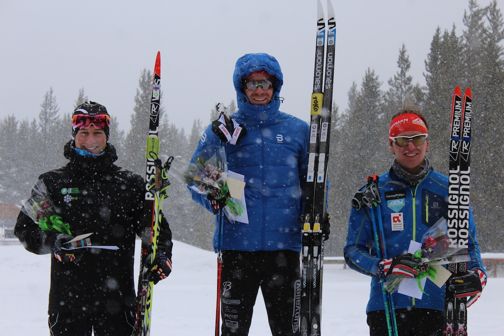 Matt Gelso (SVSEF) topping the SuperTour podium for the second-straight day on Sunday in West Yellowstone, Mont. Joining him on Sunday's 15 k classic podium: CGRP's Ben Lustgarten (l) in second and APU's Scott Patterson (r) in third.