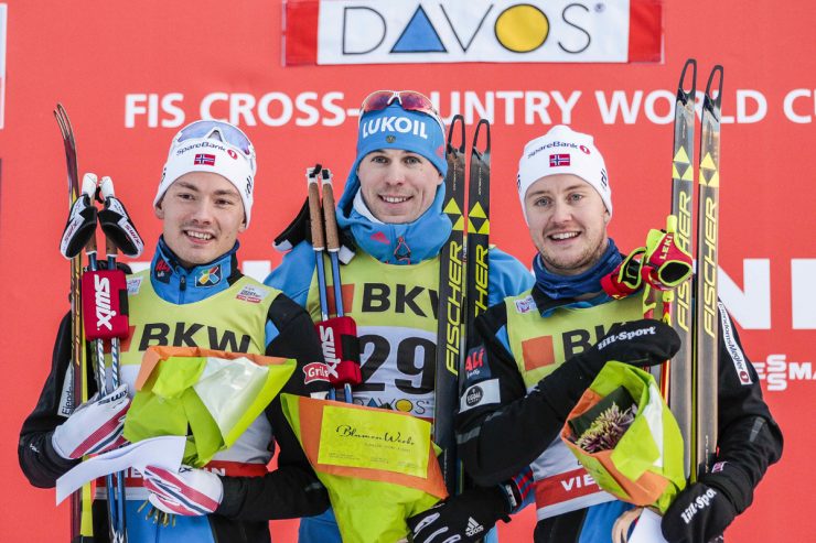 Left to right: Norway's Finn Hågen Krogh, Russia's Sergey Ustiugov, and Norwegian skier Sindre Bjørnestad Skar on top of the podium for the men's 1.6-kilometer freestyle sprint on Sunday in Davos, Switzerland.  (Photo: Fischer/NordicFocus.com)