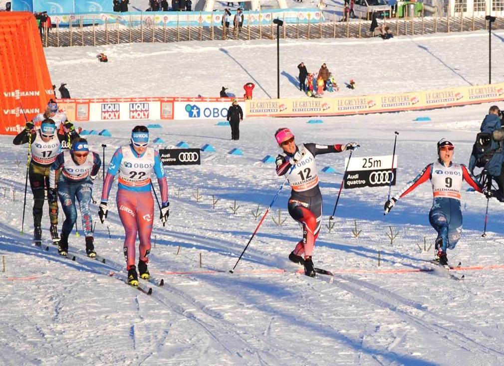 Jessie Diggins (r) lunging at the line with Russia's Yulia Belorukova (22) and Norway's Kathrine Rolsted Harsem (12) in the women's classic sprint quarterfinal. Diggins placed third in the heat and her U.S. teammate Sadie Bjornsen (second from l) finished fourth for 14th and 17th overall.  