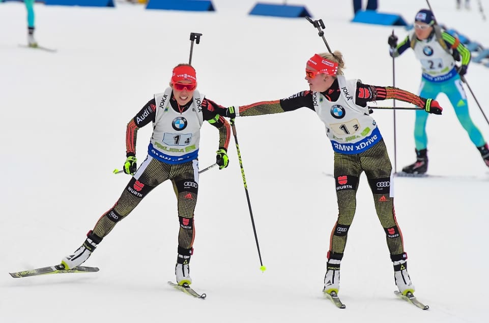 Germany's Karen Hammerschmidt (l) tagging her teammate Laura Dahlmeier in second place at the final exchange of the women's 4 x 6 k relay at the IBU World Cup in Pokljuka, Slovenia. Dahlmeier anchored the team to the win by 10.1 seconds over France. (Photo: IBU)