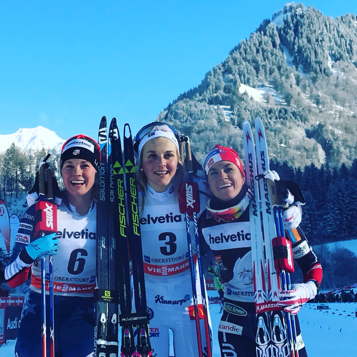 The women's 10 k skiathlon podium on Tuesday at Stage 3 of the Tour de Ski in Oberstdorf, Germany, with Sweden's Stina Nilsson (c) winning her first World Cup distance race, American Jessie Diggins (l) notching a career-best skiathlon result in second, and Norway's Heidi Weng (r) placing third. (Photo: FIS Cross Country/ witter)