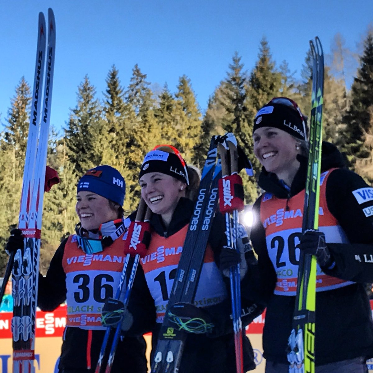 The Tour de Ski Stage 5 women's 5 k freestyle podium on Friday in Toblach, Italy, with two Americans -- Jessie Diggins (c) in first and Sadie Bjornsen (r) in third -- and Finland's Krista Parmakoski (l) in second. (Photo: FIS Cross Country/ Twitter)