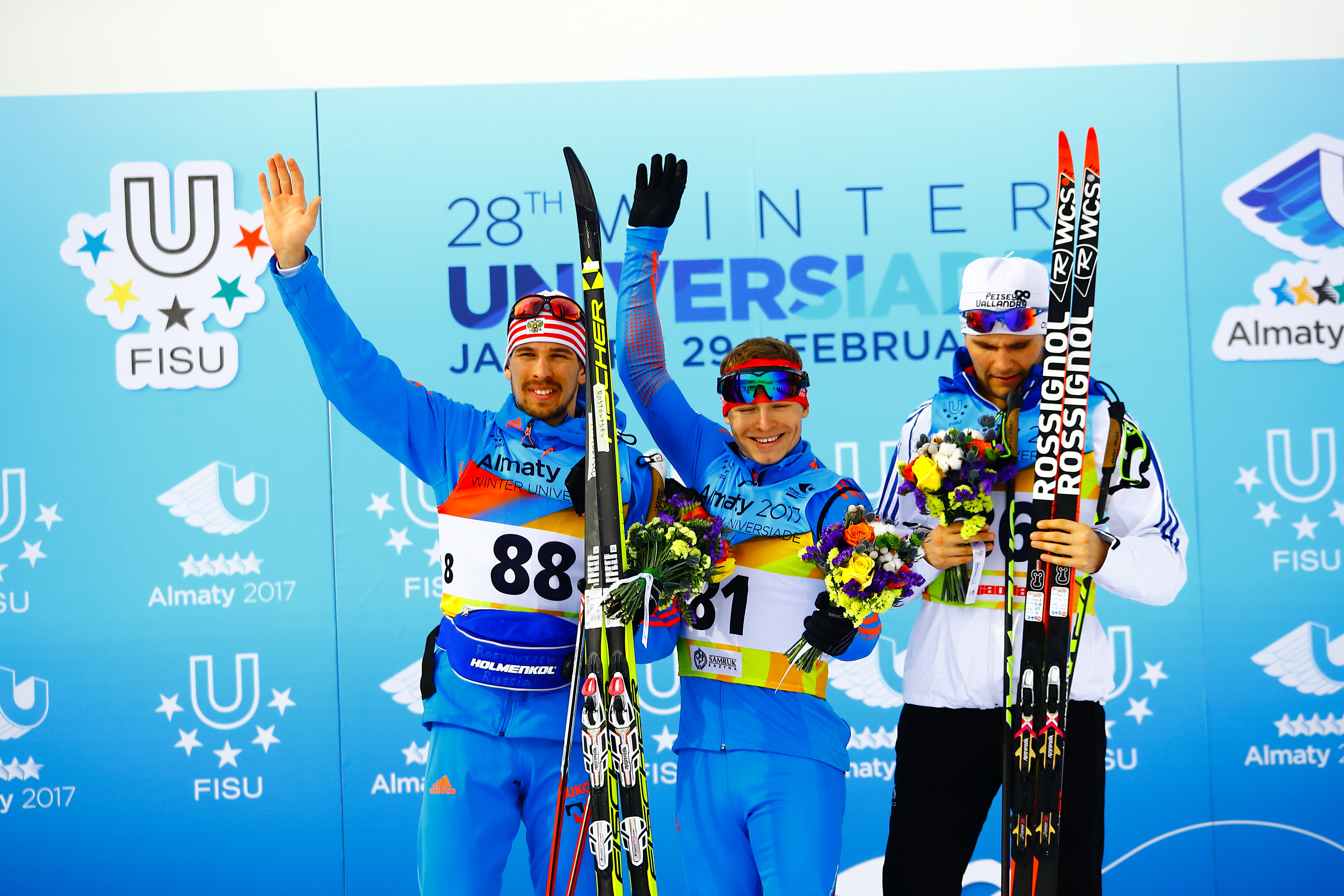 Dmitriy Rostovtsev and Valeriy Gontar of Russia (l, c) and Alexandre Pouye of France on the podium for the men's 10 k classic at 2017 World University Games in Almaty, Kazakhstan. (Photo: Almaty2017.com)