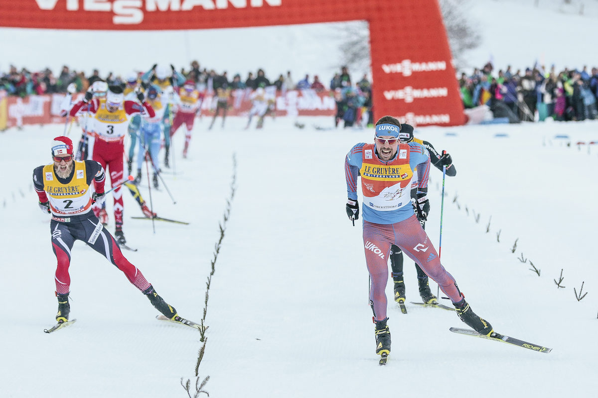 Russia's Sergey Ustiugov (r) edging Norway's Martin Johnsrud Sundby (l) on Tuesday in Stage 3 of the Tour de Ski, the men's 20 k skiathlon, in Obertsdorf, Germany, with Switzerland's Dario Cologna (behind Ustiugov) racing to third and Canada's Alex Harvey (back left, in red) racing to fourth. (Photo: Fischer/NordicFocus)