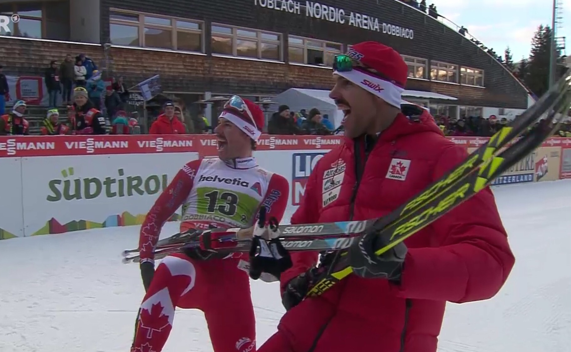 Canada's Alex Harvey (l) and Len Valjas celebrate their World Cup freestyle team sprint win on Sunday in Toblach, Italy. (Photo: ARD broadcast screenshot)