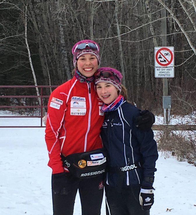 Maya MacIsaac-Jones (l) with her younger sister Anna at their home trails in Athabasca, Alberta, in late December. (Courtesy photo)
