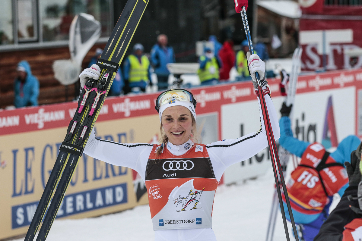 Sweden's Stina Nilsson celebrates her third victory in four stages of the 2016/2017 Tour de Ski so far, with her 10 k freestyle pursuit win on Wednesday in Oberstdorf, Germany.  (Photo: Fischer/NordicFocus)