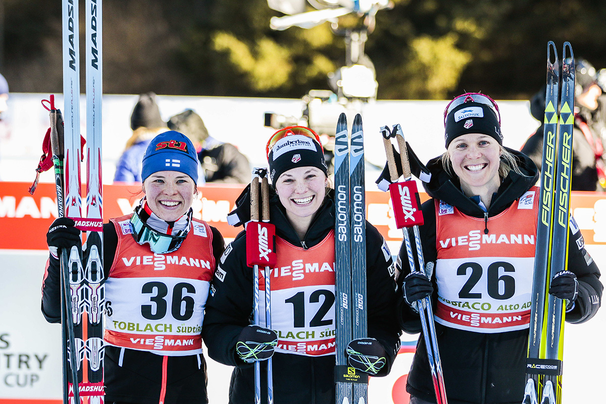 The women's podium at the 5 k freestyle on Friday at Stage 5 of the 2017 Tour de Ski, with two Americans: Jessie Diggins (c) in first and Sadie Bjornsen (r) in third, and Finland's Krista Parmakoski in second. (Photo: Fischer/Nordic Focus)