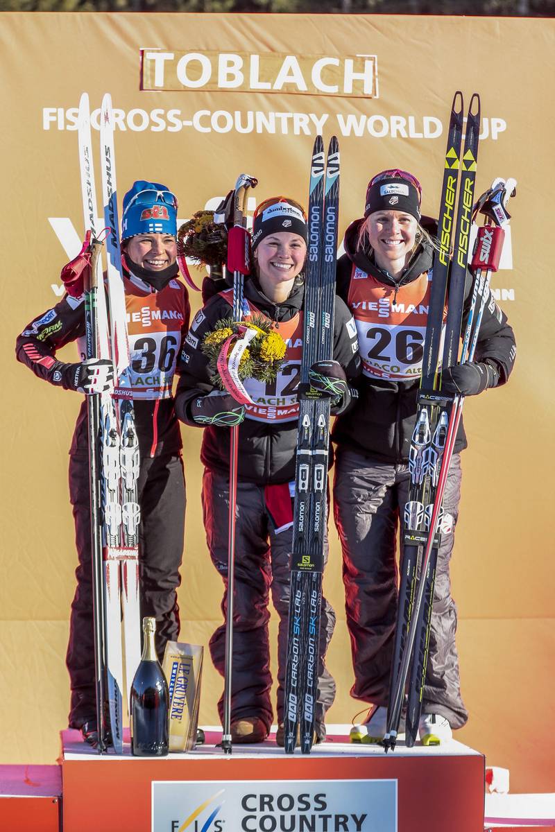 The women's podium at the 5 k freestyle on Friday at Stage 5 of the 2017 Tour de Ski, with two Americans: Jessie Diggins (c) in first and Sadie Bjornsen (r) in third, and Finland's Krista Parmakoski in second. (Photo: Salomon/Nordic Focus)