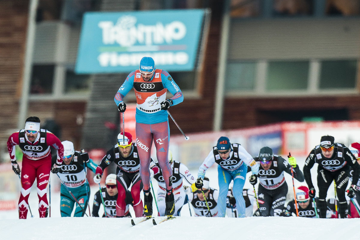 Russia's Sergey Ustiugov (front, in Tour leader's bib) leading early in the men's 15 k classic mass start on Saturday, along with Canada's Alex Harvey (l) at Stage 6 of the Tour de Ski in Val di Fiemme, Italy. (Photo: Fischer/Nordic Focus)