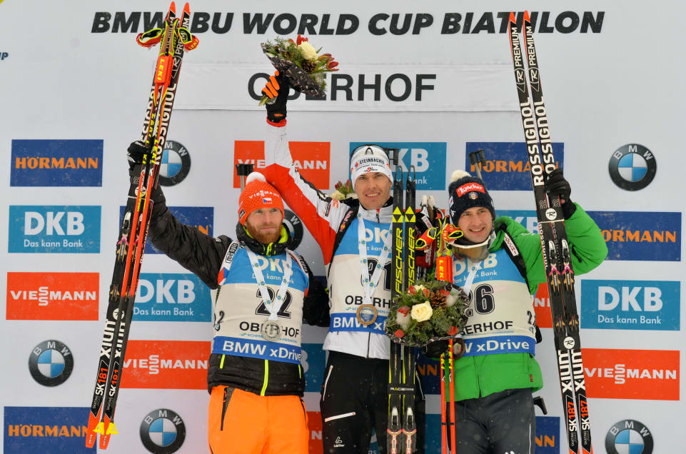 (Left to right): Czech Republic’s Michal Slesingr (second place), Austria’s Julian Eberhard (first place) and Italy’s Dominik Windisch (third place) on the podium for the men’s 10-kilometer sprint at the 2017 IBU World Cup in Oberhof, Germany. (Photo: IBU)