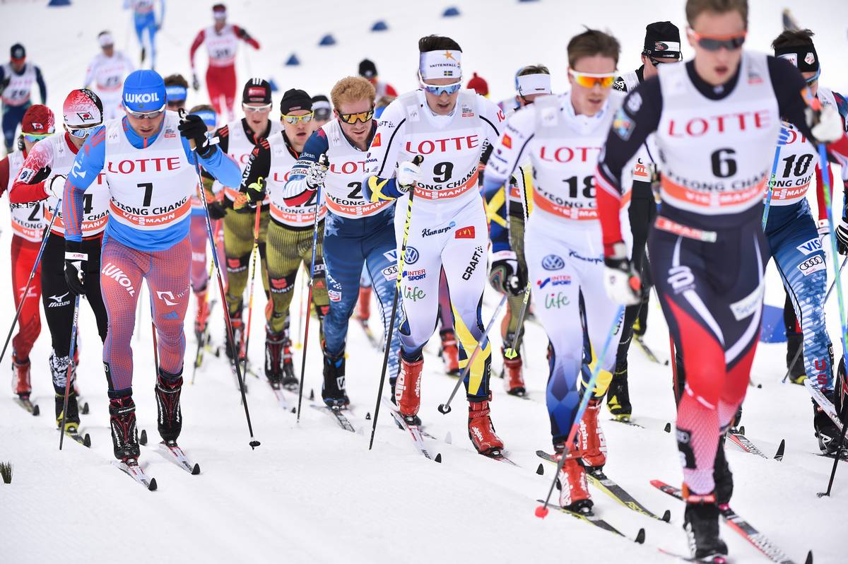 Americans Matt Gelso (bib 24) and Scott Patterson (bib 10) striding in the pack during Saturday's 30 k skiathlon in PyeongChang, South Korea. Gelso went on to finish 19th overall while Paterson placed ninth. (Photo: Salomon/Nordic Focus)