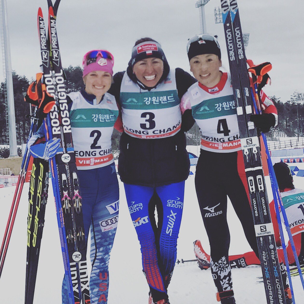 The women's 15 k skiathlon podium at the PyeongChang World Cup in South Korea, with Poland's Justyna Kowalczyk (c) in first, American Liz Stephen (l) in second, and Japan's Masako Ishida in third. (Photo: FIS Cross Country/Twitter) 