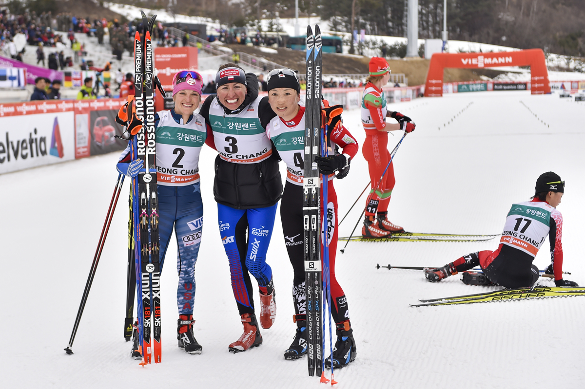 The women's World Cup 15 k skiathlon podium on Saturday in PyeongChang, South Korea, with Poland's Justyna Kowalczyk (c) in first, American Liz Stephen (l) in second, and Japan's Masako Ishida (r) in third. (Photo: Fischer/NordicFocus)