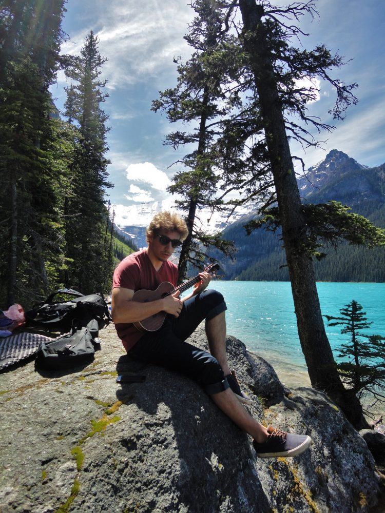 Étienne Hébert relaxing with his ukulele at Lake Louise near Canmore, Alberta, where he spent two months training with the Alberta World Cup Academy last summer. (Courtesy photo)