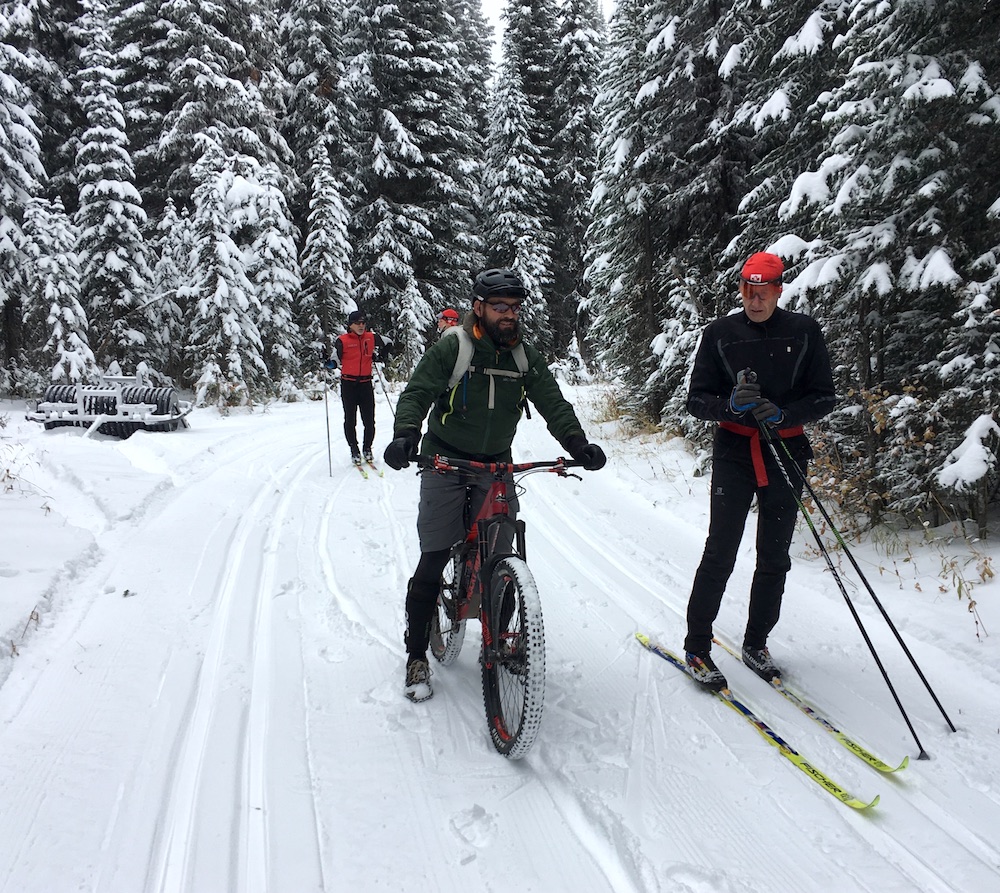 There is a difference of opinion on what season October 14th belongs to. The bikers probably would have chosen fat bikes over plus bikes if they had realized how much snow they would see on their trip from Vernon to Lumby. (Photo: Gerry Furseth)