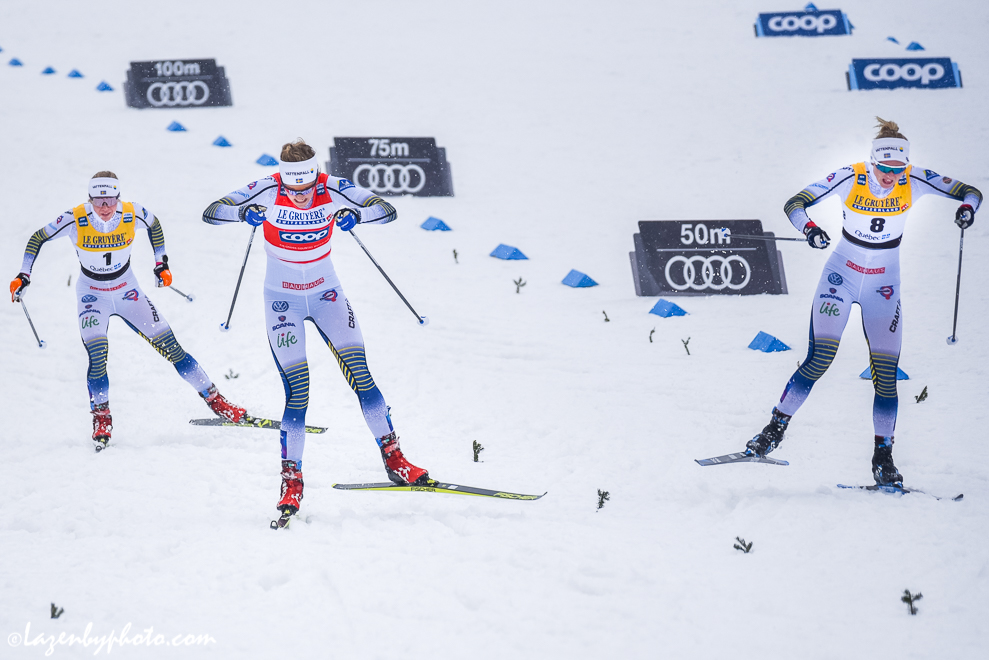 The three podium finishers approached the line. Stina Nilsson (red bib) defeated Maja Dahlqvist (#8) by 0.01 seconds with Jonna Sunding (#1). (Photo: John Lazenby)