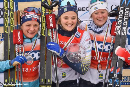 The sprint crystal globe was awarded to Stina Nilsson (centre) at the end of the day. Maiken Caspersen Falla (left) and Maja Dahlqvist were second and third. (Photo: John Lazenby)