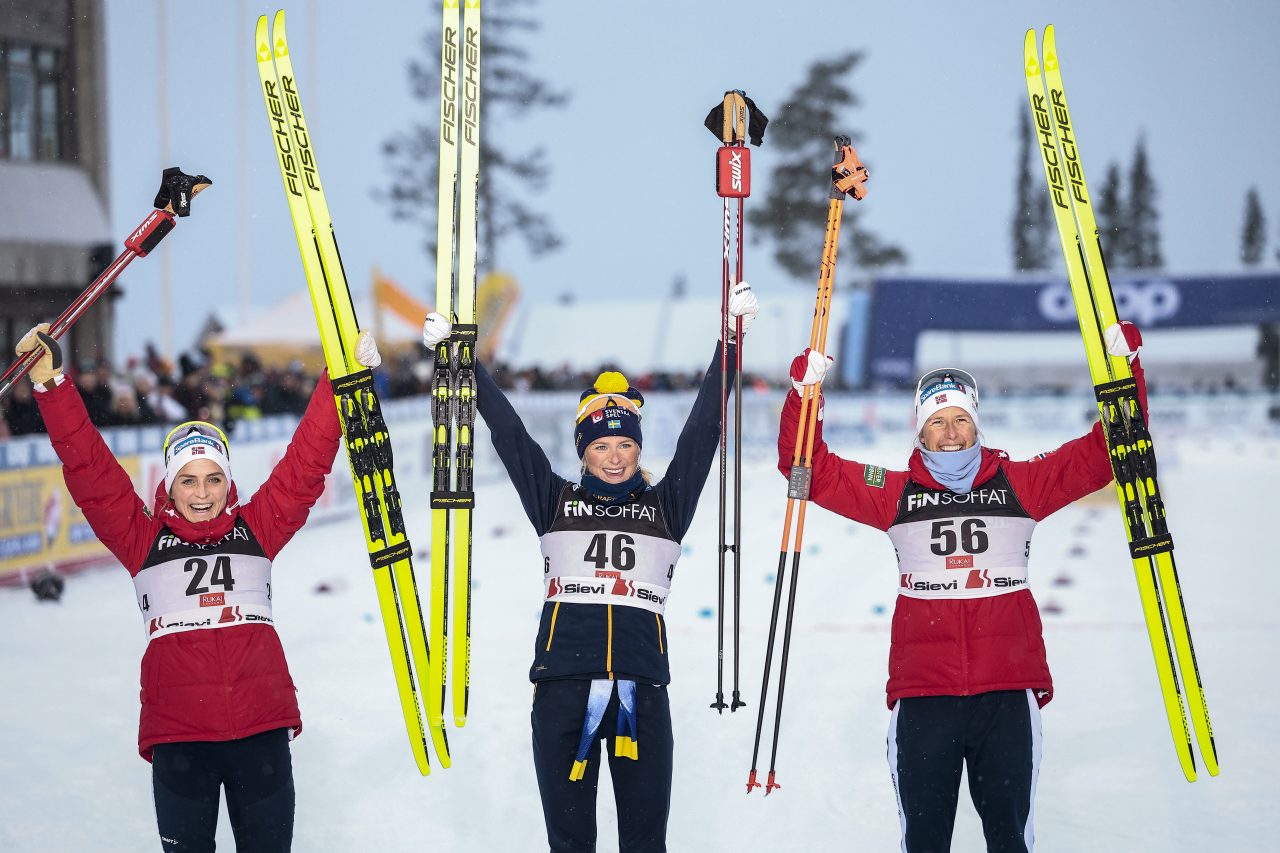 First podium of the World Cup season: Therese Johaug (NOR), Frida Karlsson (SWE), and Astrid Oyre-Slind (NOR) celebrate on the podium in Ruka. (Photo: NordicFocus)